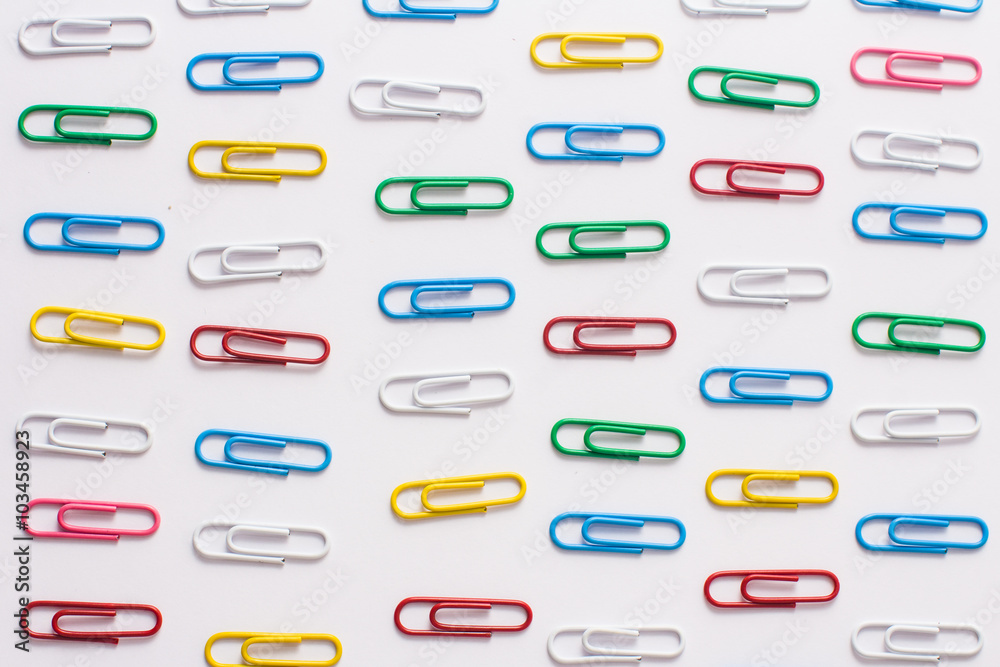 colored stationery paper clip on a white background colored stationery paper clip on a white background