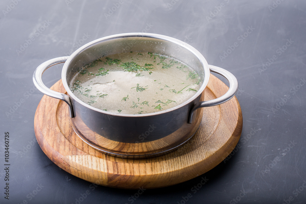 Chicken bouillon, broth, clear soup in a bowl with meat pieces o Chicken bouillon, broth, clear soup in a bowl with meat pieces o
