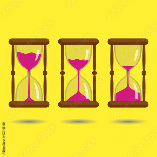 Sandglass with pink sand on yellow background