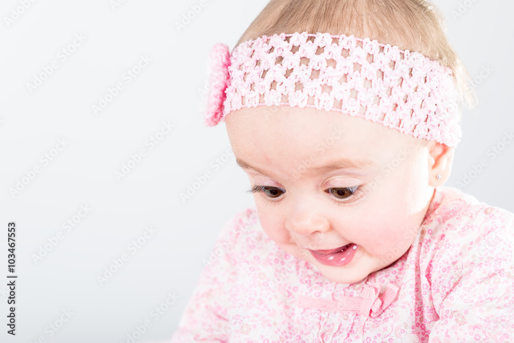 Portrait of 1 year old baby girl against grey background with copy space being amazed of her discovery Portrait of 1 year old baby girl against grey background with copy space being amazed of her discovery