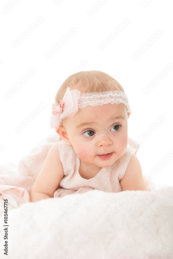 Vertical shot of adorable baby girl looking away shot against white background with copy paste Vertical shot of adorable baby girl looking away shot against white background with copy paste