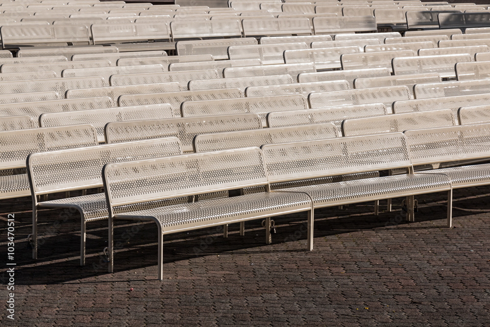 Empty audience benches in rows outdoors and facing right. Empty audience benches in rows outdoors and facing right.