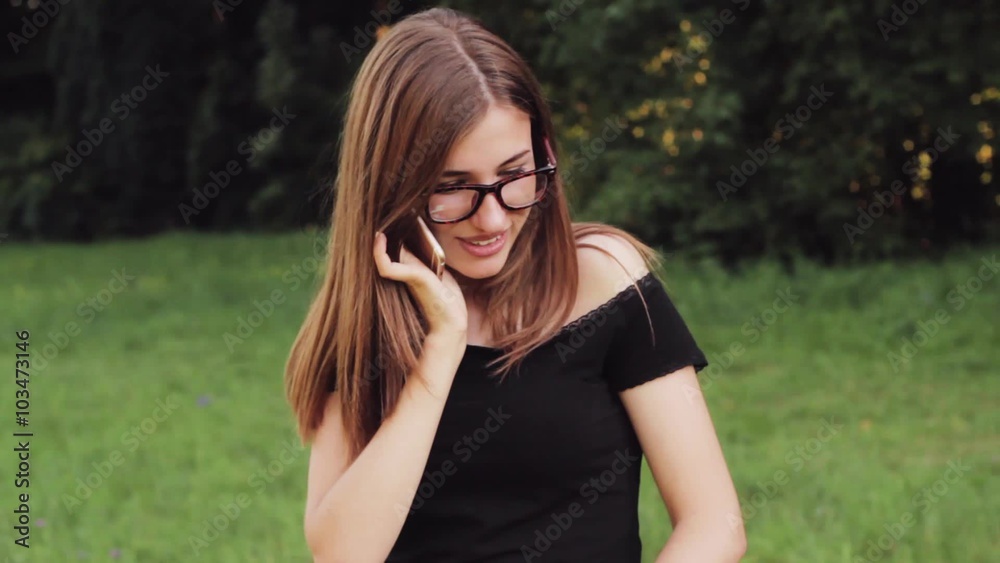 Cheerful and beautiful student talking on the phone . Cheerful and beautiful student talking on the phone .
