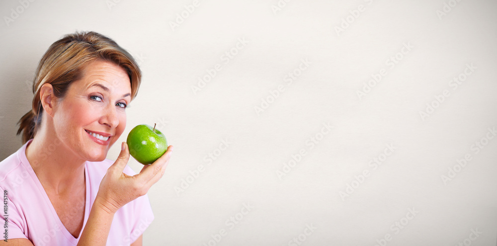 Mature smiling woman with apple. Mature smiling woman with apple.