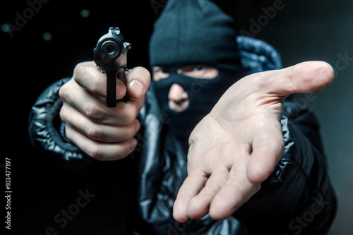 Robber with an aming gun photo