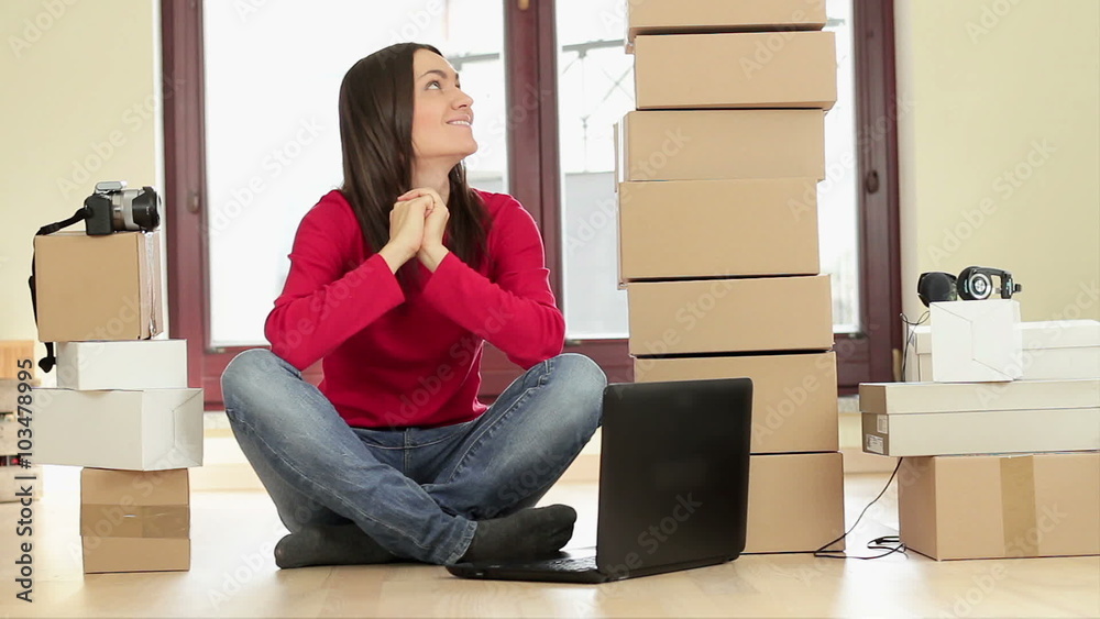 Portrait of young smiling shopping woman with laptop and stack of boxes Portrait of young smiling shopping woman with laptop and stack of boxes