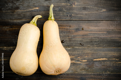 фотографія Butternut squash on wooden background