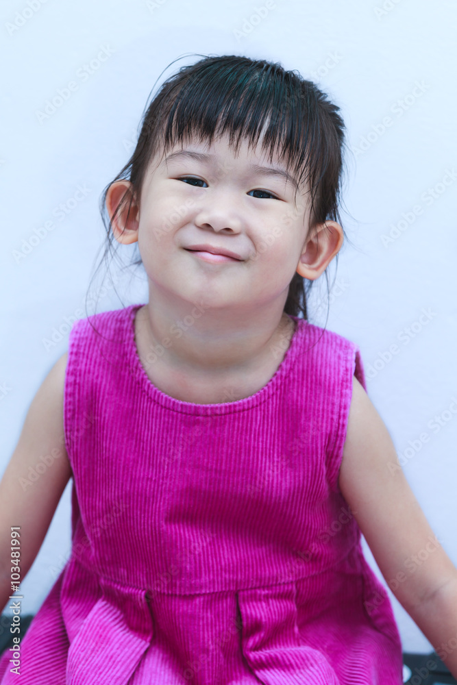 Portrait of a lovely little asian girl smiling and looking at camera Portrait of a lovely little asian girl smiling and looking at camera