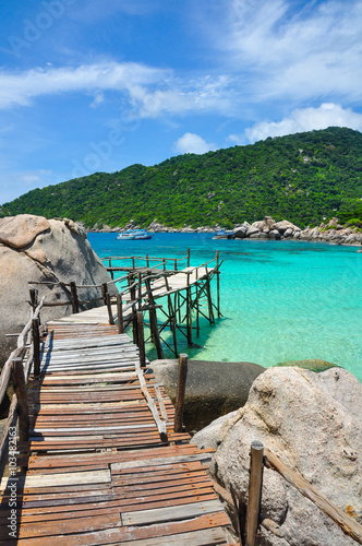 Wooden Bridge over crystal clear sea at Nangyuan Island in Thailand © jejejune