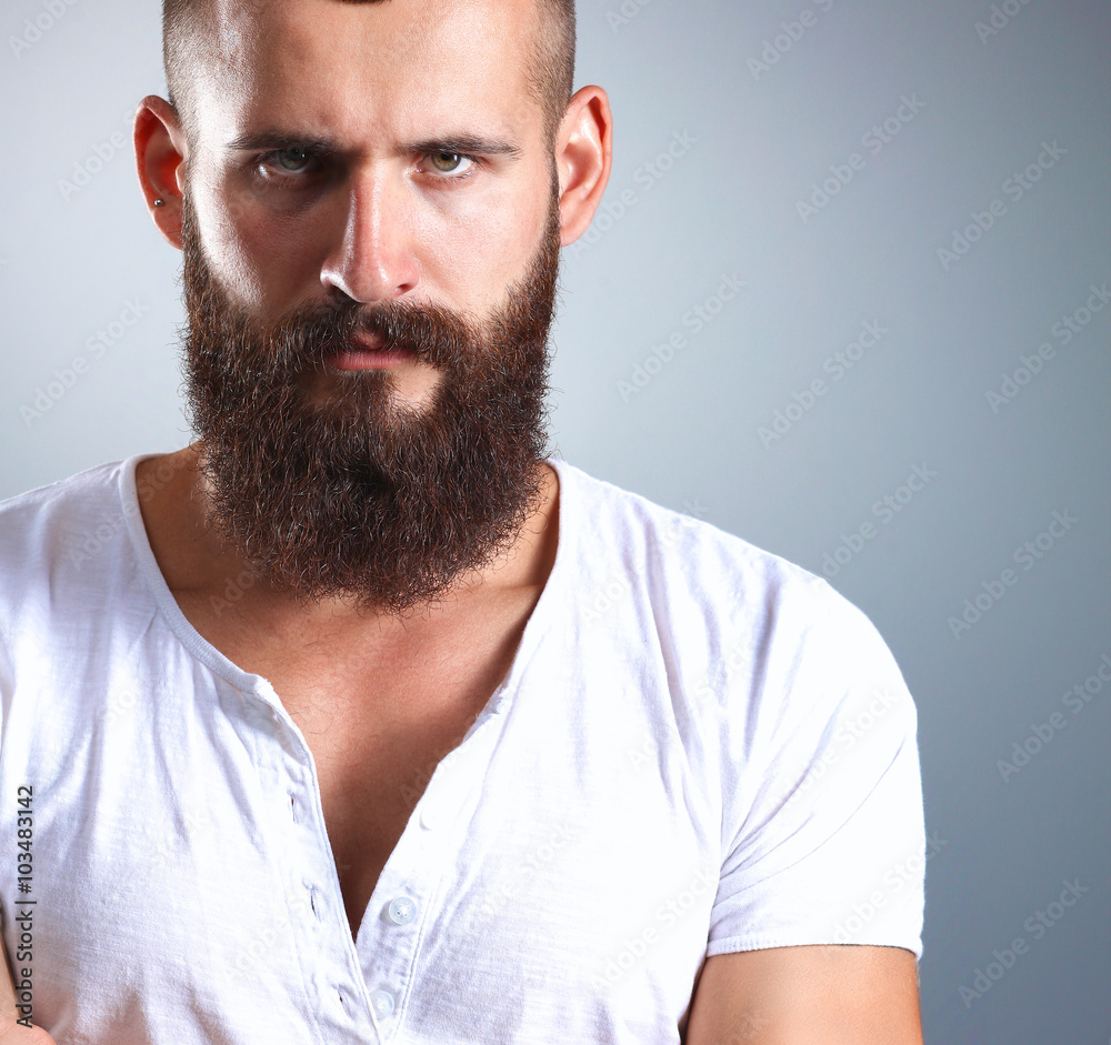 Fototapeta premium Portrait of handsome man standing, isolated on grey background