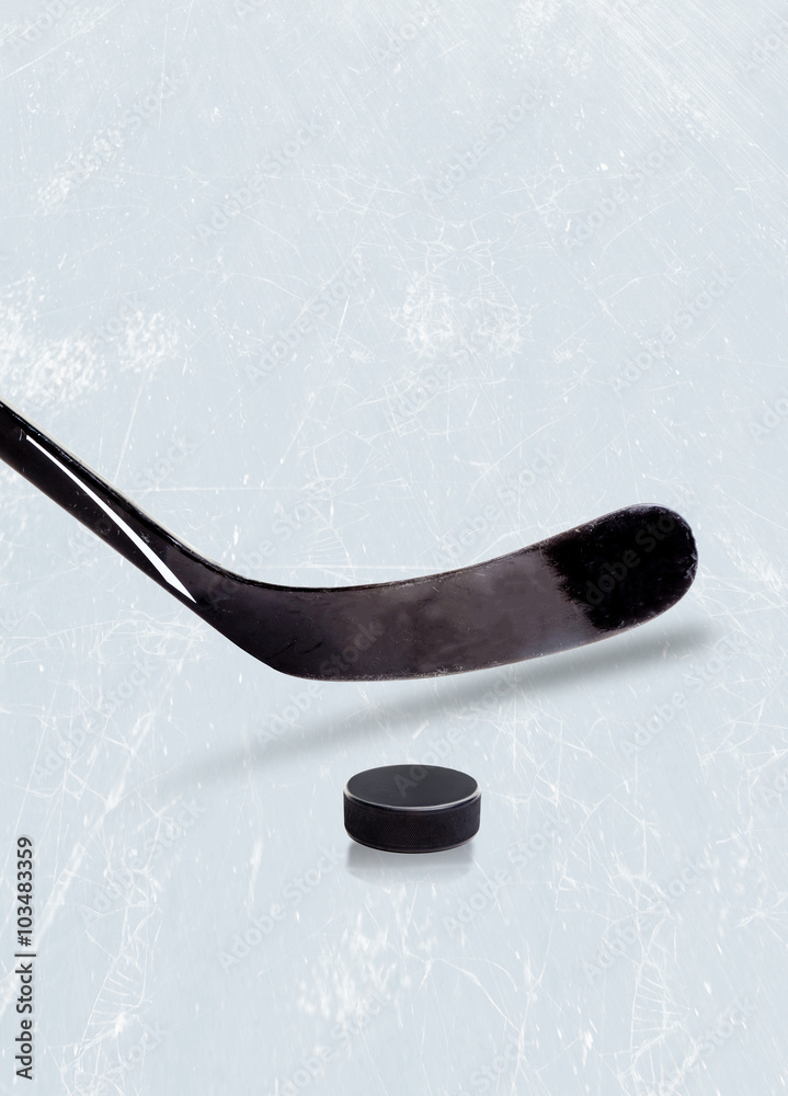 Naklejka premium Ice hockey stick and puck on ice with copy space.
