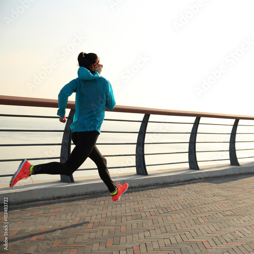 young fitness woman on sunrise seaside