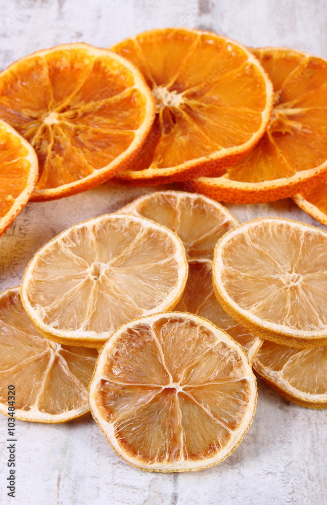 Slices of dried lemon and orange on old wooden background Slices of dried lemon and orange on old wooden background