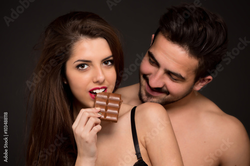 Sexy couple with chocolate in studio