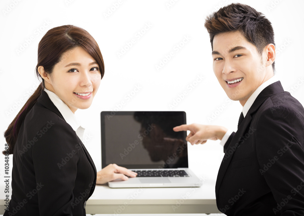 Happy business man and woman showing laptop Happy business man and woman showing laptop