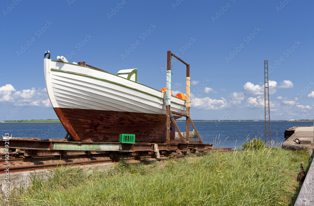 Ship on the grass near the sea in Denmark, Limfjord
