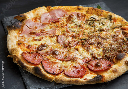 Pizza quatro stagione with salami, ham,chicken and cheese