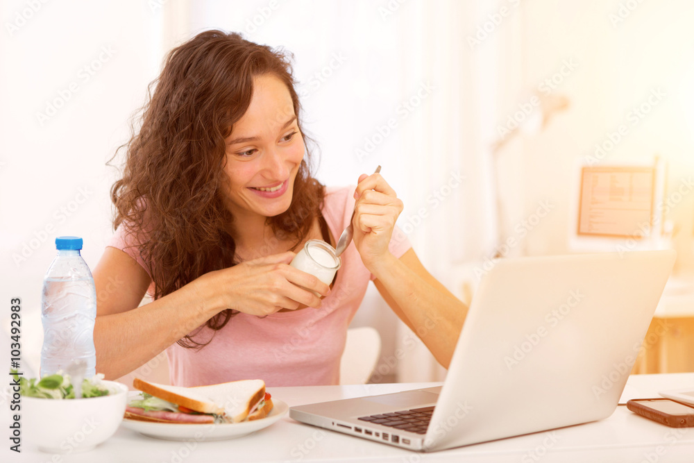Young attractive student eating while working Young attractive student eating while working