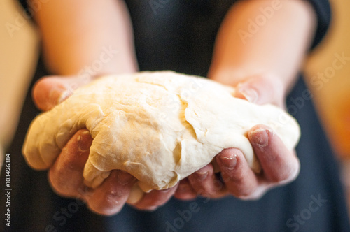 Woomens hands holding a finished clean dough