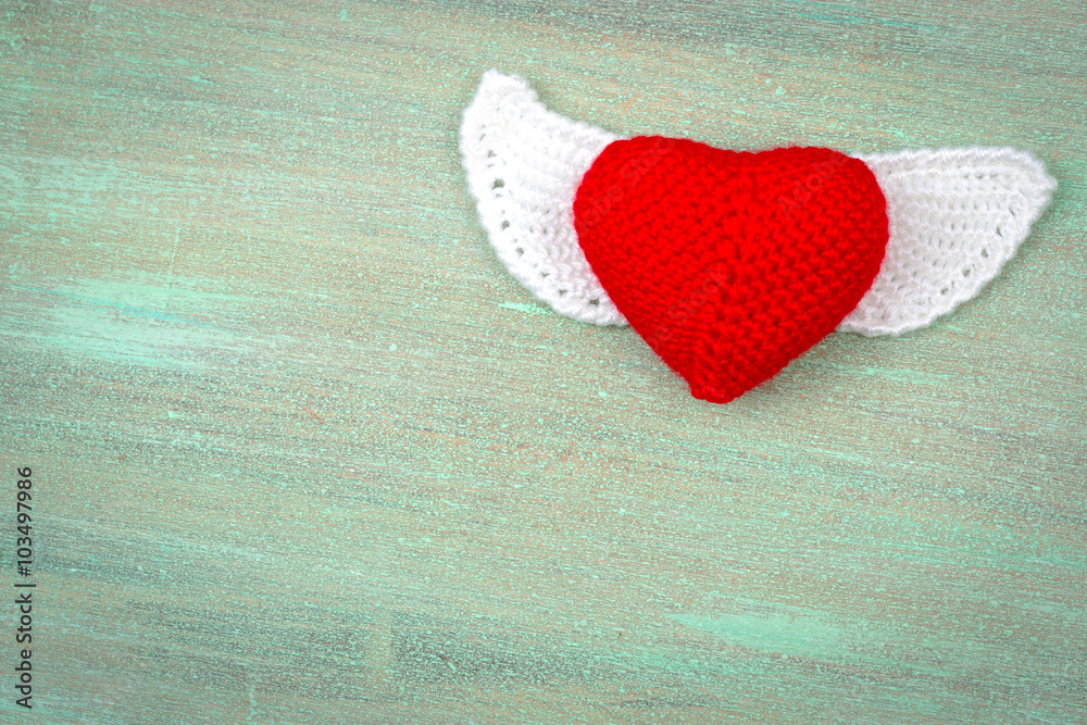 Fototapeta premium heart crocheted from threads, red, white, blue, purple, yellow,