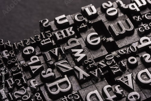 Metal Letterpress Types.
A background from many historic typographical letters in black and white with black background.
 photo