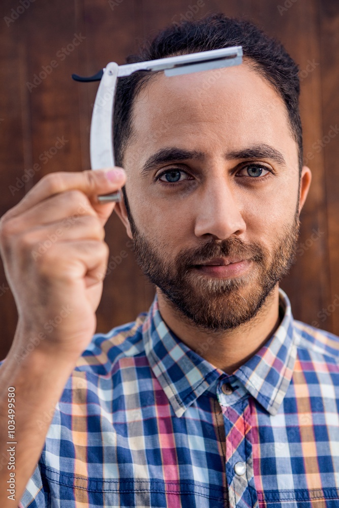Fotografia do Stock Portrait of businessman holding razor Adobe Stock
