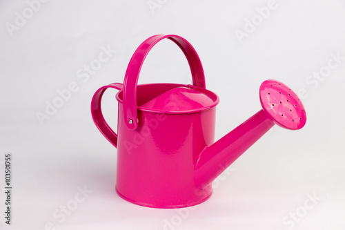 Pink watering can isolated on a white background