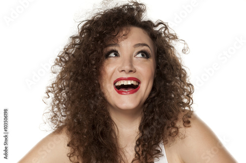 happy girl with long curly hair on a white background