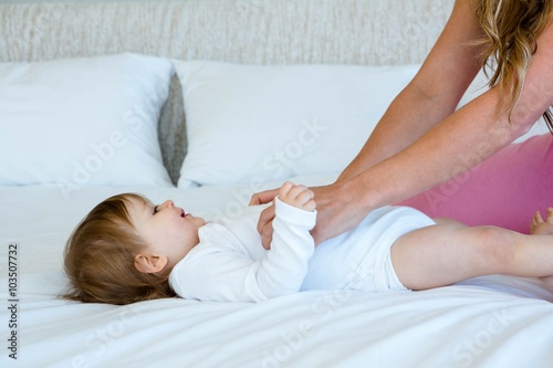 smiling baby being tickled