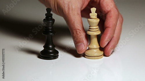 Close up of single hand setting up chess piece for competition or strategy concept