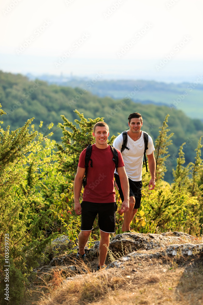 Two men hiking on the top of mountain Two men hiking on the top of mountain