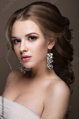 Beautiful blond girl with perfect skin  evening make-up  wedding hairstyle and accessories. Beauty face.