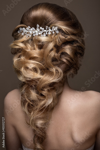 Beautiful blond girl with perfect skin, evening make-up, wedding hairstyle and accessories. Beauty face. photo