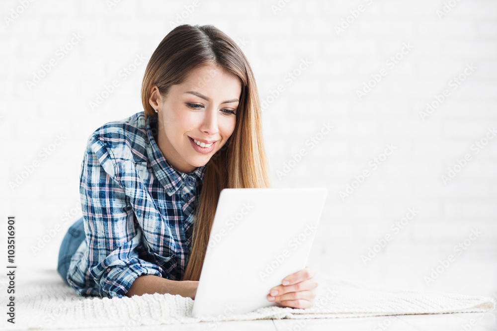 Beautiful woman using digital tablet at home Beautiful woman using digital tablet at home