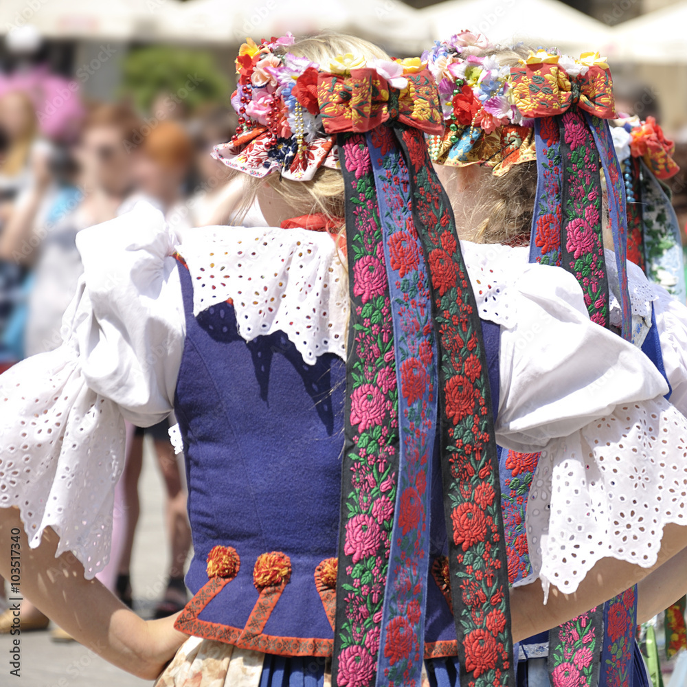 Three young women wearing a traditional Polish folk costume