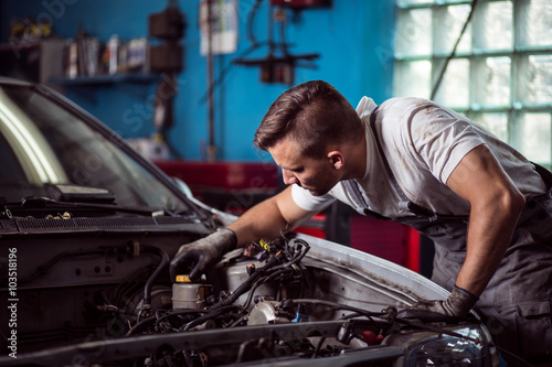 Car mechanic repairing vehicle © Photographee.eu