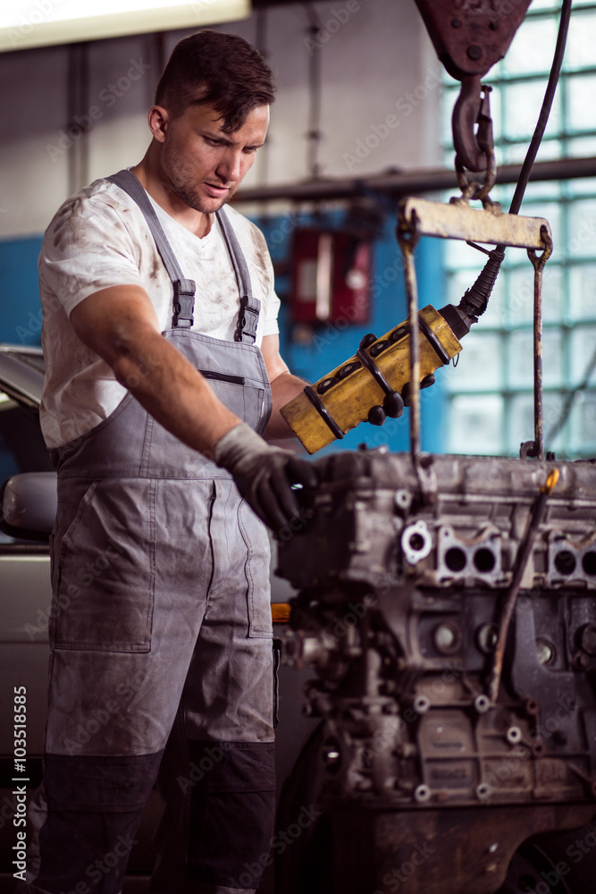 Car mechanic diagnosing broken engine Car mechanic diagnosing broken engine