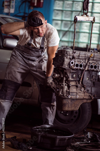 Tired car mechanic at work