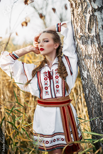 Young girl on the summer field  in national Belarus clothes  fas