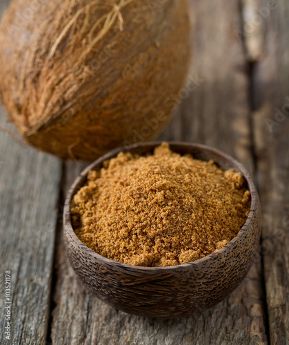 coconut palm sugar on wooden surface