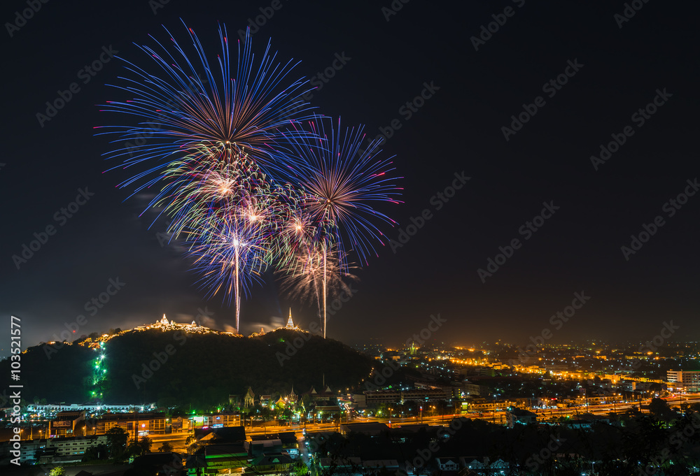 Firework over the mountain between the city.