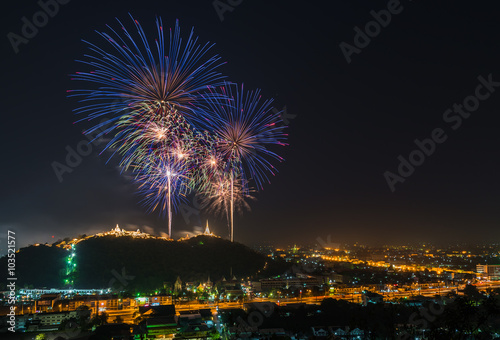 Firework over the mountain between the city. © chanwitohm
