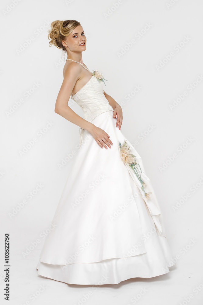 Portrait of gorgeous bride wearing wedding dress over grey backg Portrait of gorgeous bride wearing wedding dress over grey backg