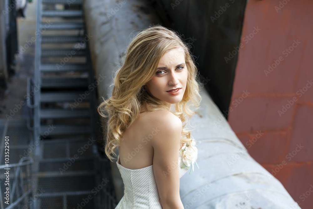 Fototapeta premium Young beautiful blonde woman in bridal dress