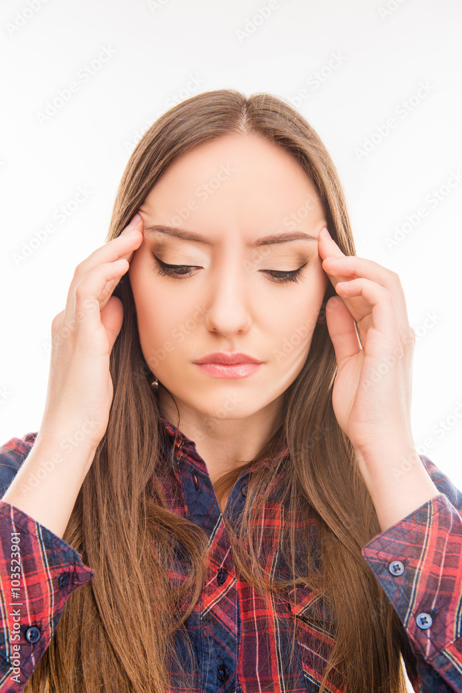  sad young  woman  suffering from headache and touching her temp