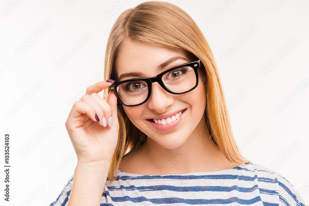 Close up photo of cheerful girl touching her glasses