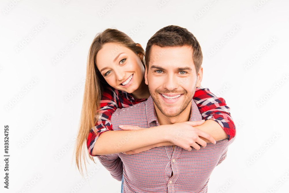 Happy young man piggybacking his girlfriend Happy young man piggybacking his girlfriend