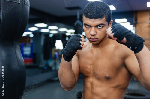 Male boxer workout with boxing bag © Drobot Dean