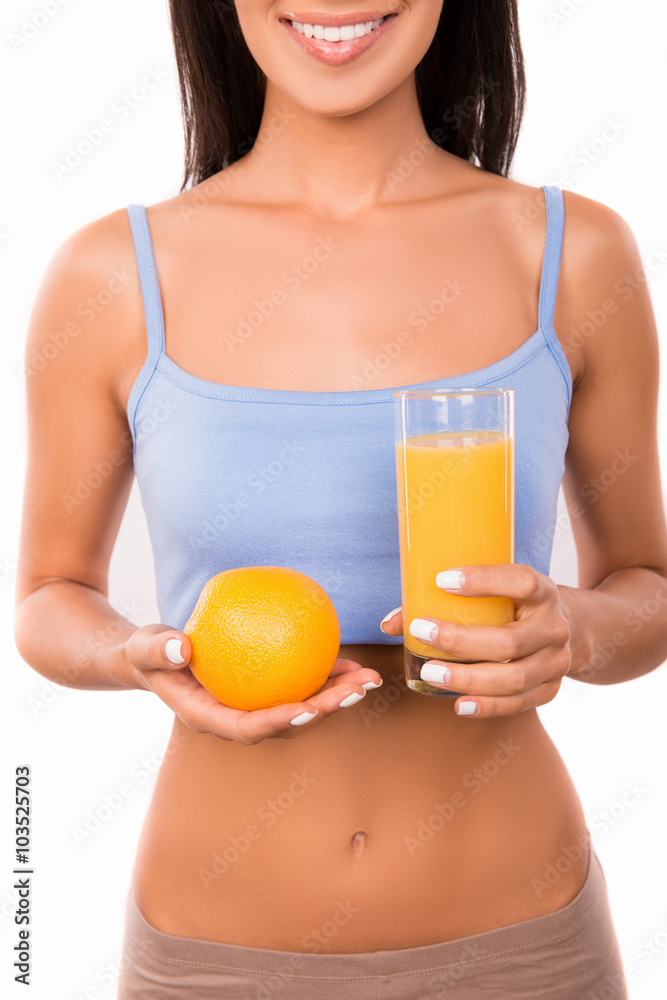 cheerful sexy woman with orange and glass of orange juice cheerful sexy woman with orange and glass of orange juice