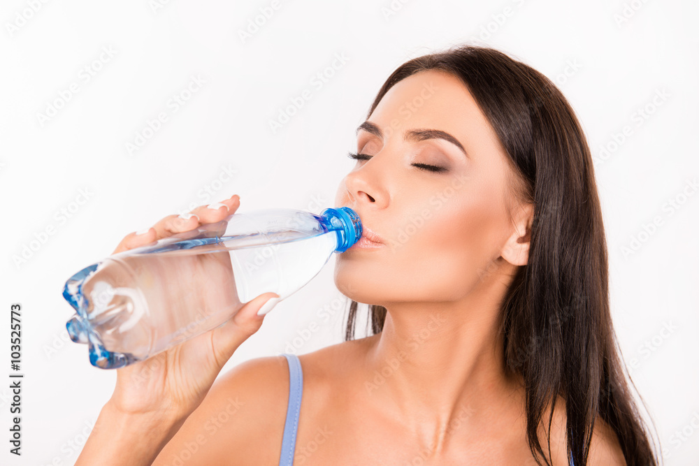 Happy cute girl holding a bottle with water Happy cute girl holding a bottle with water